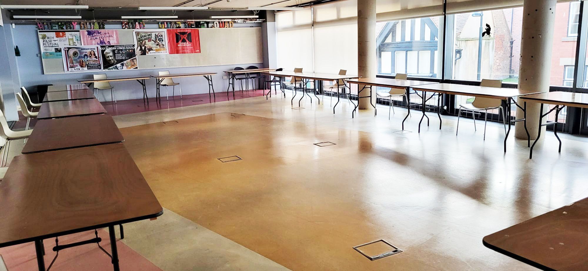 Studio 1 is a bright, open space with windows along one wall and tables set out in a U-shape around the edge